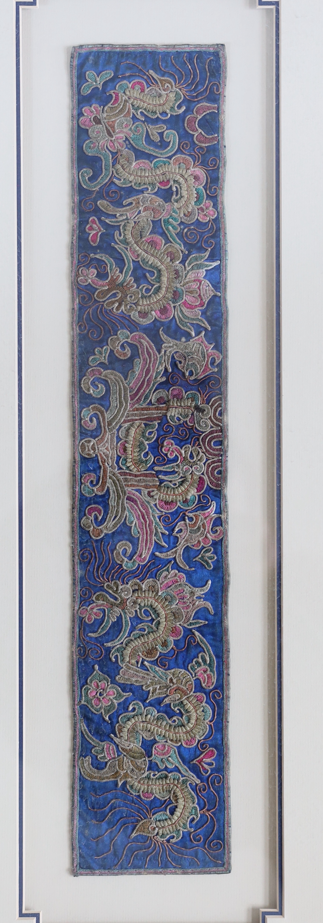 Two 19th century Chinese sleeve bands, embroidered in rich polychromes silks, designed with unusual fine appliqué embroidery, giving the panels a three dimensional effect, largest: 8cm wide, 50cm long
